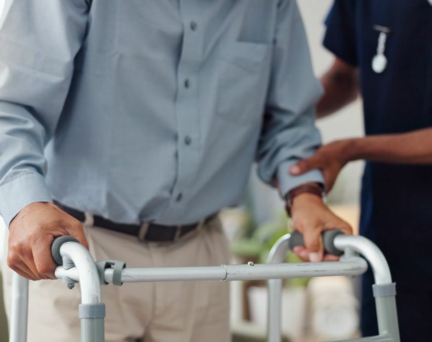 Hands, nurse and walking frame with senior person for healthcare service, retirement support and homecare. Medical worker or caregiver helping an elderly patient with disability for physiotherapy